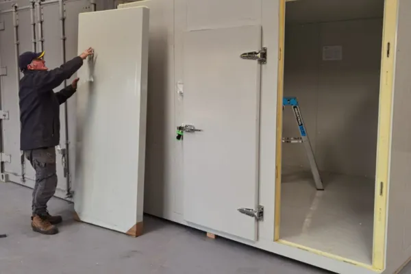 Staff Member Installing a Walk in Chiller