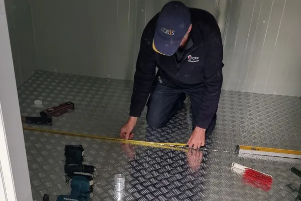 Staff Member Installing Aluminium Flooring in a Walk in Chiller in NZ